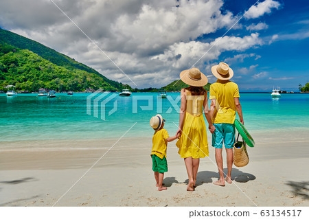 Family with three year old boy on beach. 63134517