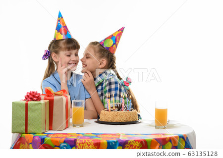 Children keep secrets and talk while sitting at Children keep secrets and talk while sitting at 63135128