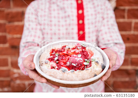 Fruit pizza. Pizza with raspberries, mascarpone and mint leaves. Traditional wood oven in restaurant, Italy. Original neapolitan pizza. Red hot coal. Fruit pizza. Pizza with raspberries, mascarpone and mint leaves. Traditional wood oven in restaurant, Italy. Original neapolitan pizza. Red hot coal. 63135180