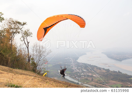 Paraglider on the ground. Paragliding flying over 63135998