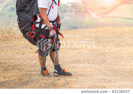 Paraglider on the ground. paragliders with full Paraglider on the ground. paragliders with full 63136037