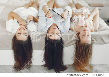 Three girls have pajamas party at home Three girls have pajamas party at home 63138580