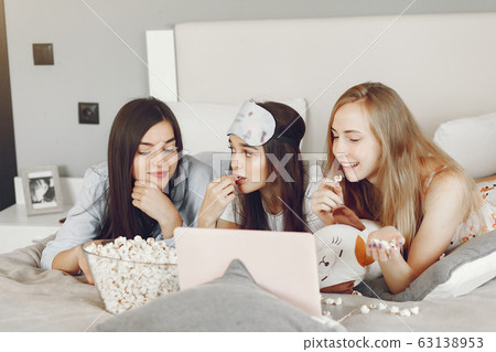 Three girls have pajamas party at home 63138953