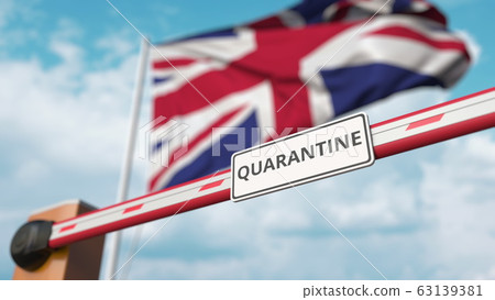Barrier gate with QUARANTINE sign being closed with flag of the UK as a background. British border closure or infection related isolation 63139381