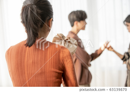 Back view of woman holding gift box 63139870