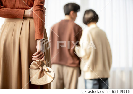 Broken heart image of the back of a woman holding a gift box 63139916