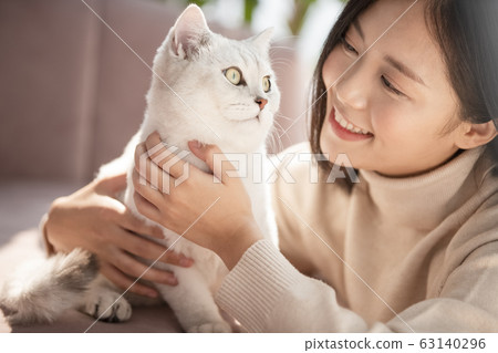 Young woman living with cat Young woman living with cat 63140296