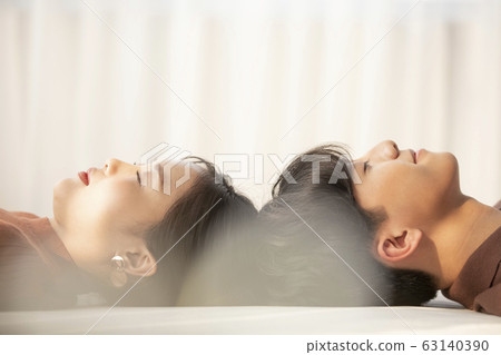 Young couple cuddling in their room 63140390