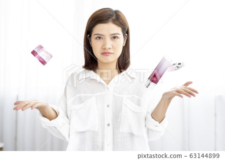 Young woman suffering from skin care Young woman suffering from skin care 63144899