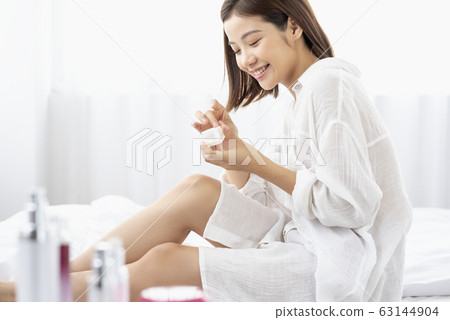 A young woman doing skin care A young woman doing skin care 63144904