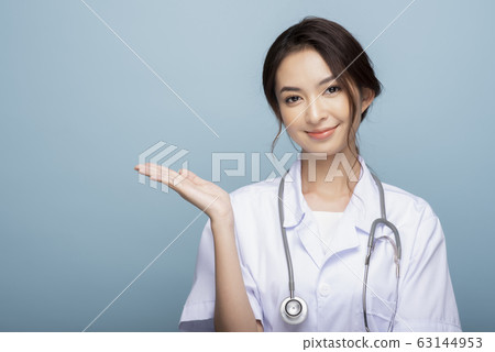 Female medical portrait on blue background Female medical portrait on blue background 63144953