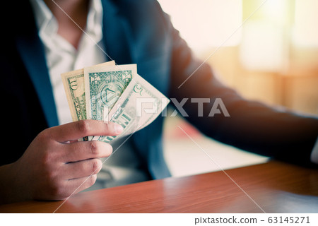 Business man giving banknotes and holding money 63145271