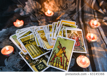 Tarot card with candlelight on the darkness 63145366