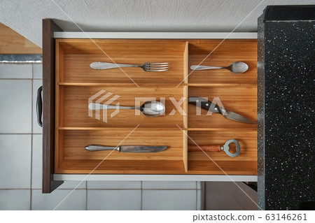 Minimalist kitchen tools put away in a drawer 63146261