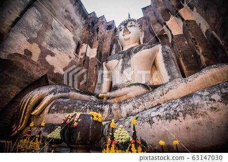 Old buddha statue on wall in ancient temple 63147030