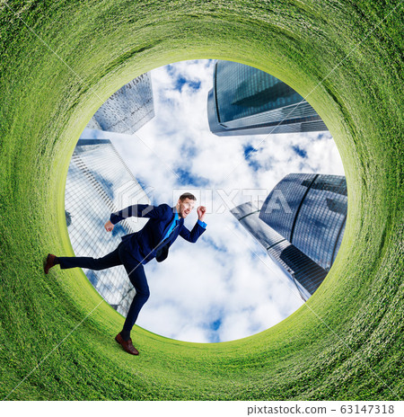 Young businessman running into green field circle. 63147318