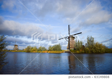 Old Dutch windmill. Blue sky background. Old Dutch windmill. Blue sky background. 63149808