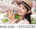 beautiful girl and cherry blossom 63152294