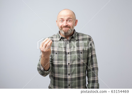 Senior handsome man showing italian gesture that means what do you want Senior handsome man showing italian gesture that means what do you want 63154469