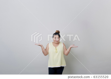 Plump Young Asian Woman smiling showing something Plump Young Asian Woman smiling showing something 63155520