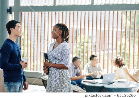 Coworkers before meeting 63156260