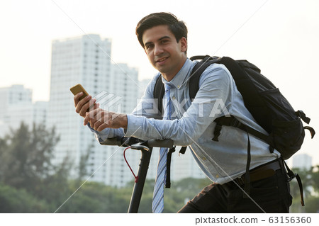 Young smiling businessman with big backpack 63156360