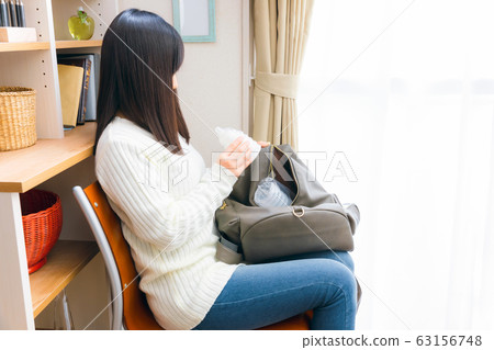 Woman preparing disposable baby bottle Woman preparing disposable baby bottle 63156748
