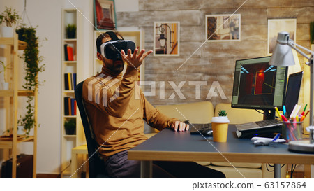 Game developer with virtual reality headset 63157864