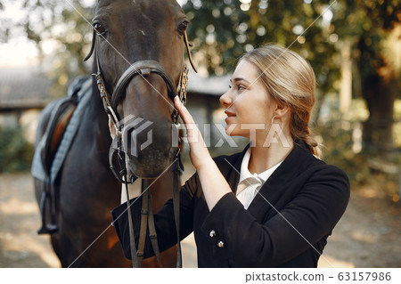 The rider in black form trains with the horse The rider in black form trains with the horse 63157986
