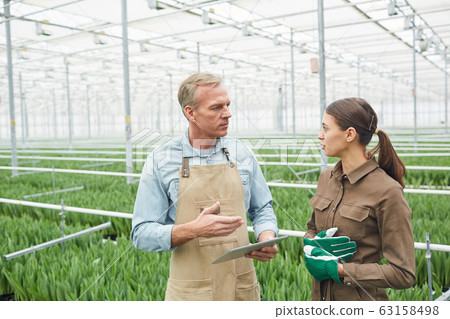 Two Workers Talking in Plantation Two Workers Talking in Plantation 63158498
