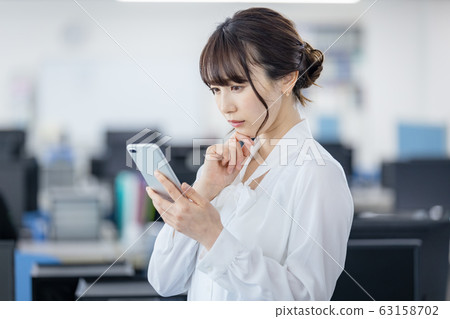 Young woman, smartphone, grumpy, sad, anxiety 63158702
