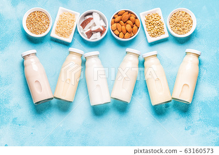 A bottles of alternative milk and ingredients. A bottles of alternative milk and ingredients. 63160573