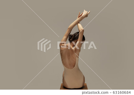Young graceful tender ballerina on pastel studio background 63160684