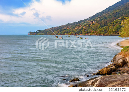 Beach with tropical vegetation and boats over the 63163272