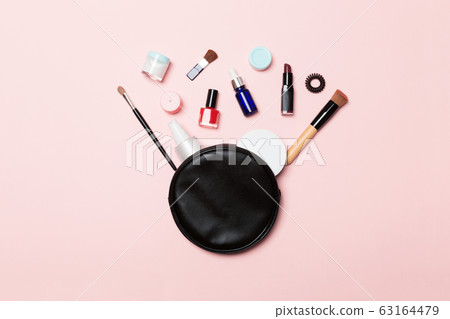 Top view od cosmetics bag with spilled out make up Top view od cosmetics bag with spilled out make up 63164479