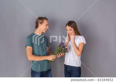 Young couple studio isolated on grey wall concept 63164652