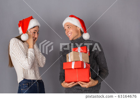 Young couple studio isolated on grey wall concept Young couple studio isolated on grey wall concept 63164676