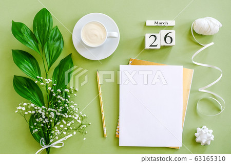 Wooden cubes calendar March 26. Notepad, cup of 63165310