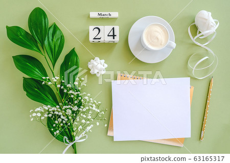 Wooden cubes calendar March 24. Notepad, cup of 63165317