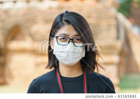 Woman wearing face mask protect filter against air Woman wearing face mask protect filter against air 63165691