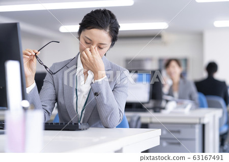 Troubled woman in the office Troubled woman in the office 63167491