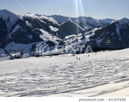 Beautiful ski panorama: Ski slope with ski lifts (chairlifts) and unidentifiable skiers 63167686