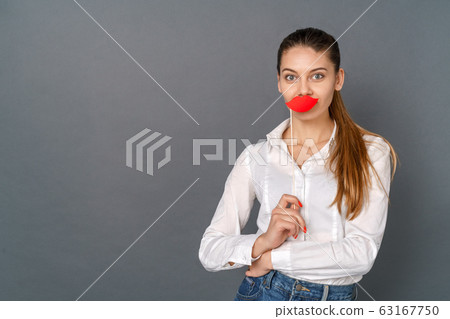 Young woman student studio isolated on gray posing with crafted red lips 63167750