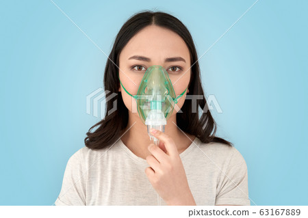 Young adult asian girl with oxygen mask on face Young adult asian girl with oxygen mask on face 63167889