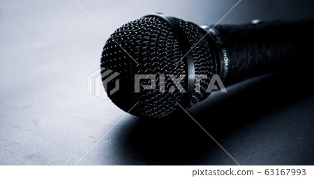 Close up of black microphone on a black background. 63167993