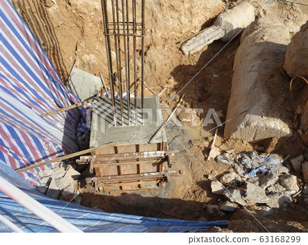 KUALA LUMPUR, MALAYSIA -SEPTEMBER 6, 2019: Pile cap and column stump under construction at the construction site. Constructed using reinforced concrete with plywood timber as a form work. KUALA LUMPUR, MALAYSIA -SEPTEMBER 6, 2019: Pile cap and column stump under construction at the construction site. Constructed using reinforced concrete with plywood timber as a form work. 63168299