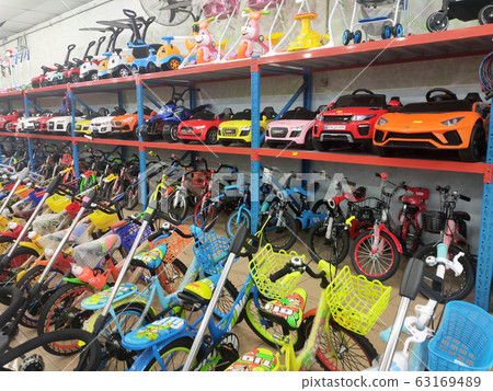 Various types of bikes are on display in the store. Kids bike to an adult bike. Various types of bikes are on display in the store. Kids bike to an adult bike. 63169489