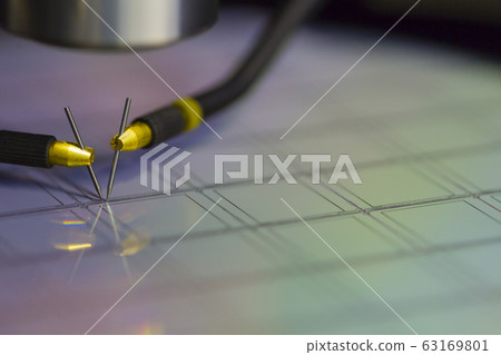 Close up of examining a sample of microchip 63169801