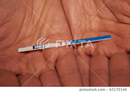 Woman holding pregnancy test, New life and new family concept. Shallow dof. Woman holding pregnancy test, New life and new family concept. Shallow dof. 63170148