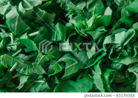 Fresh bright green spinach. Chopped spinach as a background. 63170388